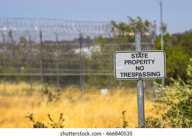 State Property No Trespassing Sign Against Blurred Background