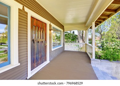 Stately Completely Renovated Craftsman Home Exterior: Covered Empty Entrance Porch Accented With White Trim. This Historic Home Was Designed And Constructed By Henry Schneider.