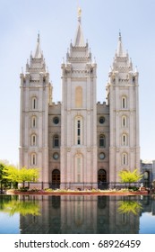The stately Mormon temple in Salt Lake City, Utah, with reflections in the pond in front.