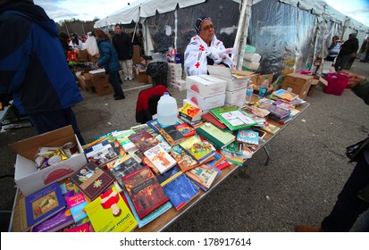 STATEN ISLAND, NEW YORK CITY - NOVEMBER 4 2012: Volunteers & National Guard Assembled At New Dorp High School To Render Aid To People Recovering From Hurricane Sandy. Donated Books For Kids Fill Table