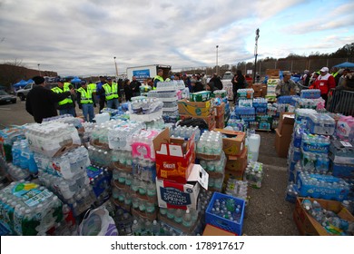 STATEN ISLAND, NEW YORK CITY - NOVEMBER 4 2012:Volunteers & National Guard Assembled At New Dorp High School To Render Aid To People Recovering From Hurricane Sandy.Stacks Of Water Ready To Distribute