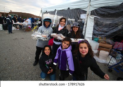 STATEN ISLAND, NEW YORK CITY - NOVEMBER 4 2012: Volunteers & National Guard Assembled At New Dorp High School To Render Aid To People Recovering From Hurricane Sandy. Young Volunteers Pose Before Tent