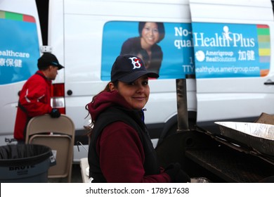 STATEN ISLAND, NEW YORK CITY - NOVEMBER 4 2012: Volunteers & National Guard Assembled At New Dorp High School To Aid People Recovering From Hurricane Sandy.Young Lady Working The Grill In Baseball Cap