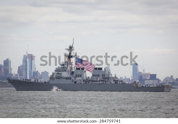 STATEN ISLAND, NY - MAY 20 2015: The American Flag flies\
from the USS Stout (DDG 55) as the ship travels on the Upper Bay\
towards Manhattan during the Parade of Ships, which begins Fleet\
Week. 