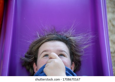 Static Hair Raising Girl On Slide