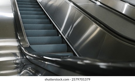 Station escalators. Empty escalator steps, moving staircase. Comfort and safety of movement of passengers.