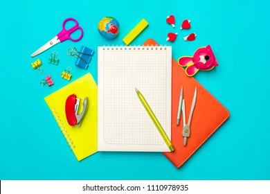 Stationary, Back To School,summer Time, Creativity And Education Concept.School Supplies -dividers, Pencils, Paper Clips,note,stapler And Notepad, Globe On Blue Background,flatlay.Mock Up.Top View