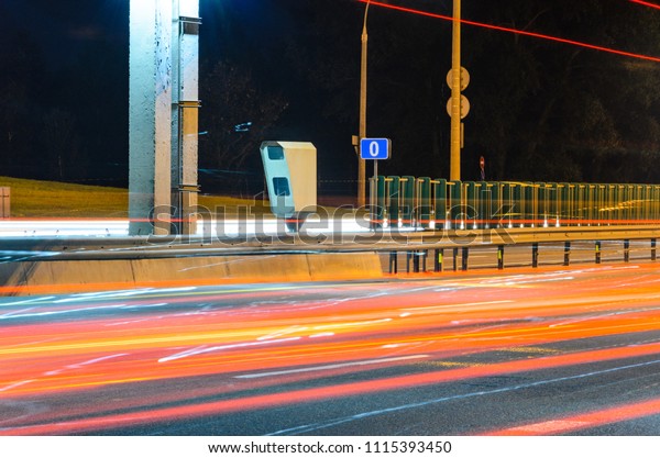 Stationary Car Speed Radar Near a Highway\
Road. Night Road Traffic\
Background