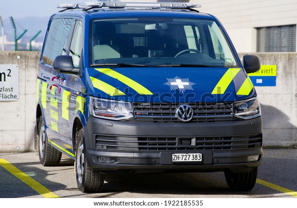 Stationary customs police van at\
Zurich airport on a sunny winter day. Photo taken February 22nd,\
2021, Kloten, Switzerland. Translation of Zoll (German) is\
customs.