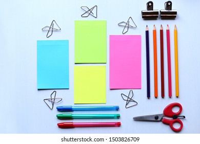 Сomposition of stationery: colored stickers for notes, colored pencils, paper clips, pens, scissors
