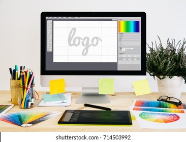  Stationery desktop with design stuff, computer and graphic tablet. Logo design. - Shutterstock ID 714503992