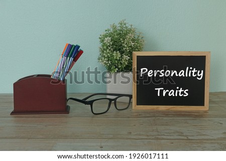 stationery and eyeglass on table. Personality traits concept.