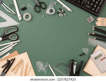 stationery items around of image on green background. Back to school background, banner with copy space. Student's or engineer's supplies. Office objects on dark green background. Calculator, keyboard - Powered by Shutterstock