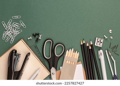 stationery items around of image on green background. Back to school background, banner with copy space. Student's or engineer's supplies. Office objects on dark green background. Calculator, keyboard - Powered by Shutterstock