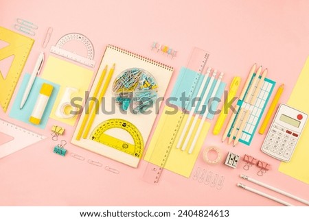 stationery items for girls or women on light pink background. Back to school. Female Student's, pupil's or engineer's supplies. Office objects on pastel pink background. Calculator, pen, pencil etc.