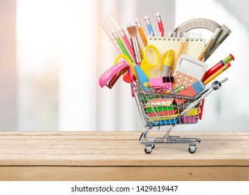 Stationery objects in mini supermarket cart on  background - Shutterstock ID 1429619447