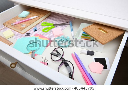 Stationery in open desk drawer closeup