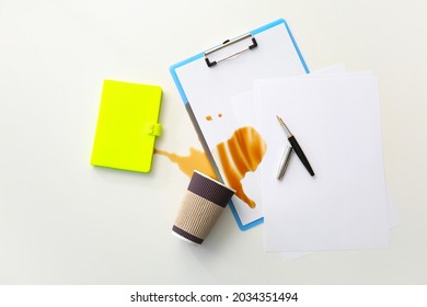 Stationery, Overturned Cup And Spilled Coffee On Office Table