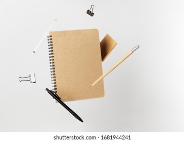 Stationery set  Levitation notepad  pencils  pen  sticker   binder clips  Copy space notebook   notes  Writing tools  Office supplies  Isolated gray backdrop