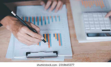 statistical analyst using calculator to calculate and read reports , graphs and charts, business statistics ,Analysis and improvement of corporate strategy ,manage financial and marketing documents