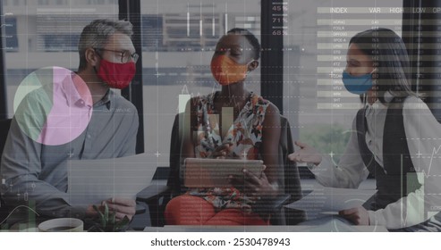 Statistical data processing over diverse office colleagues wearing face masks discussing at office. Business data and analytics concept - Powered by Shutterstock