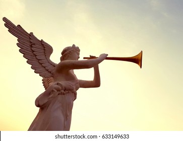 Statue Of An Angel Blowing A Trumpet