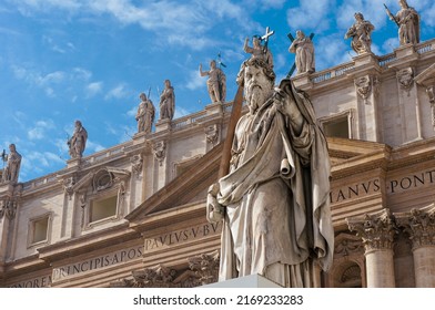 Statue of Apostle Paul in front of the St Peter's Basilica, Vatican, Rome, Italy. Detail of the facade exterior on the blue sky background. Renaissance sculpture of the Apostle Paul with a sword.