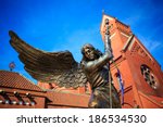 Statue of Archangel Michael with outstretched wings, thrusting a spear into a dragon before the Catholic Church of St. Simon and St. Helena on Independence Square in Minsk, Belarus