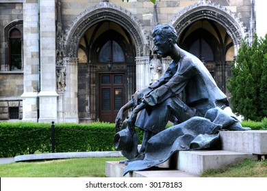 Statue Of Atilla Jozsef, Budapest. House Of Parliament Visible In The Background