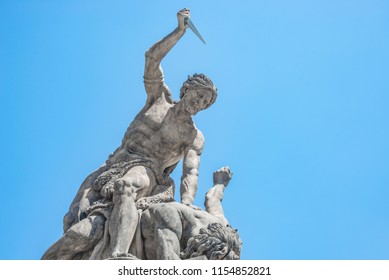 Statue Of Battling Titan With A Dagger At The Main Gate Of Hradcany Castle In Prague, Czech Republic, Blue Sky, Sunny Day