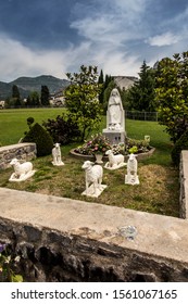 Statue of Bernadette of Lourdes with sheep in Lourdes, France