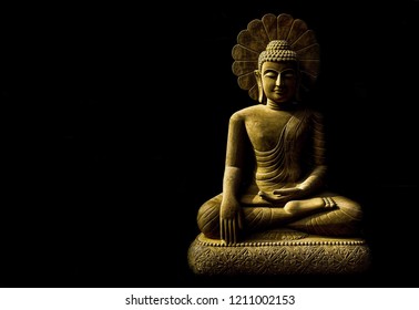 Statue of Buddha sitting in meditation
With black space on the right hand side