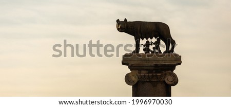 The statue of the Capitoline Wolf with Romulus and Remus and the Coliseum in background, Rome, Italy