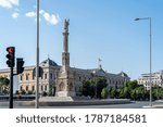 Statue of Colon and National Library of Spain in Castellana Avenue in Madrid.