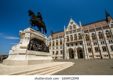 Statue Of Count Gyula Andrassy In Front Of Sunlit Hungarian Parliament Building From The South, Budapest, Hungary