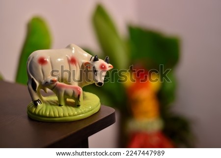 Statue of a cow with a calf suckling her
