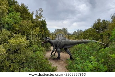 Statue of a dinosaur in nature