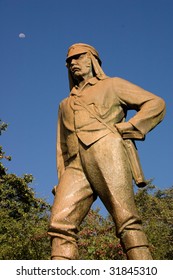 Statue Of Dr. Livingstone At Victoria Falls Zimbabwe With The Moon In The Background