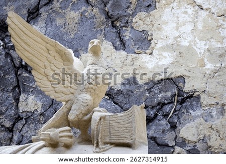 Statue of an eagle with large wings close-up on a sky background. Symbol of freedom and liberty	
