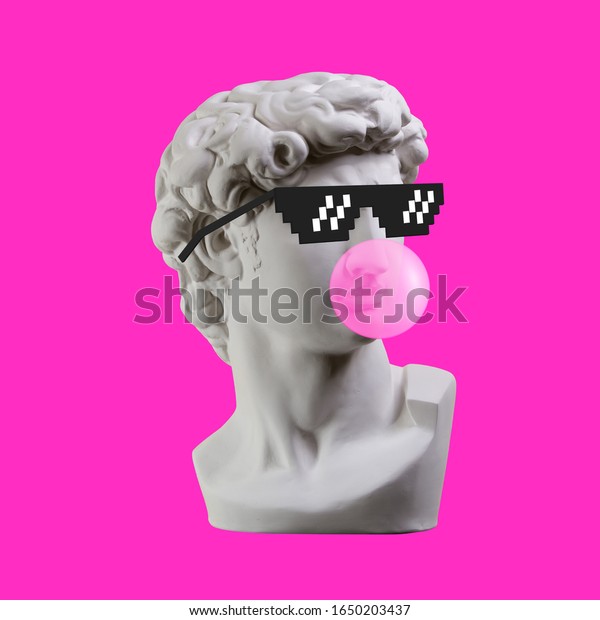 Statue. Earphone. Isolated. Gypsum statue of David\'s\
head. Man. Creative. Plaster statue of David\'s head in pixel\
glasses. Minimal concept\
art.
