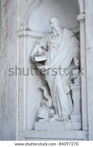 Statue embedded in cathedral