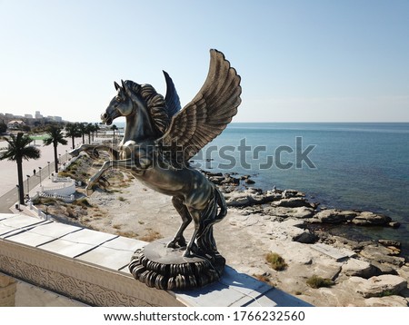 Statue flying horse pegasus a greek mythology figure on the roof of amphitheater in Aktau, Kazakhstan. 