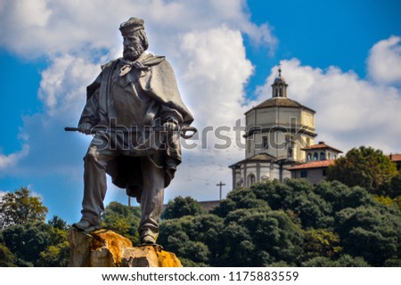 A statue of Giuseppe Garibaldi, an Italian national hero involved in the Italian unification in the 1800s. The statue is placed in Turin, Italy. In the background, the 