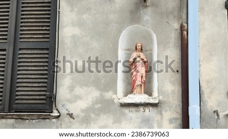 a statue of Jesus Christ in a niche in a wall in a rural house