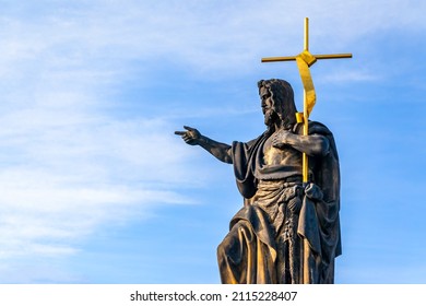 Statue of John the Baptist (by Josef Max, 1857) on Charles Bridge in Prague, Czech Republic. Large copyscace over the sky