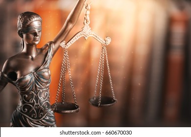 Statue of justice and book. - Shutterstock ID 660670030
