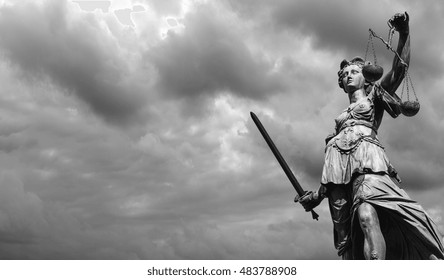 Statue of justice goddess (Justitia) with cloudy sky, Black and white 