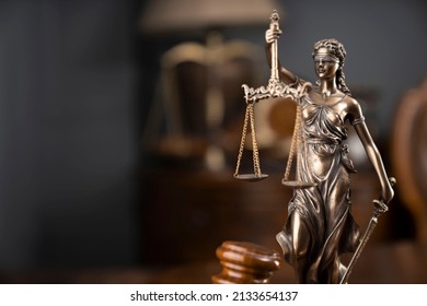 Statue Of Justice And Judge's Gavel On Wooden Table. Law Office Concept.