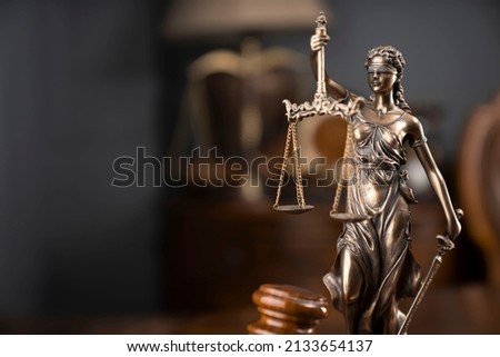Statue of justice and judge's gavel on wooden table. Law office concept.