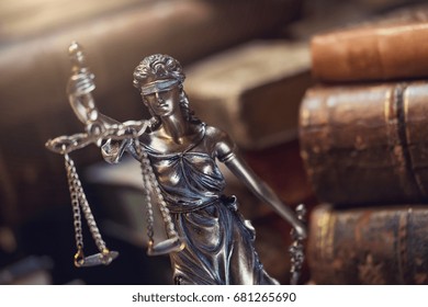 Statue of justice with old books - Shutterstock ID 681265690